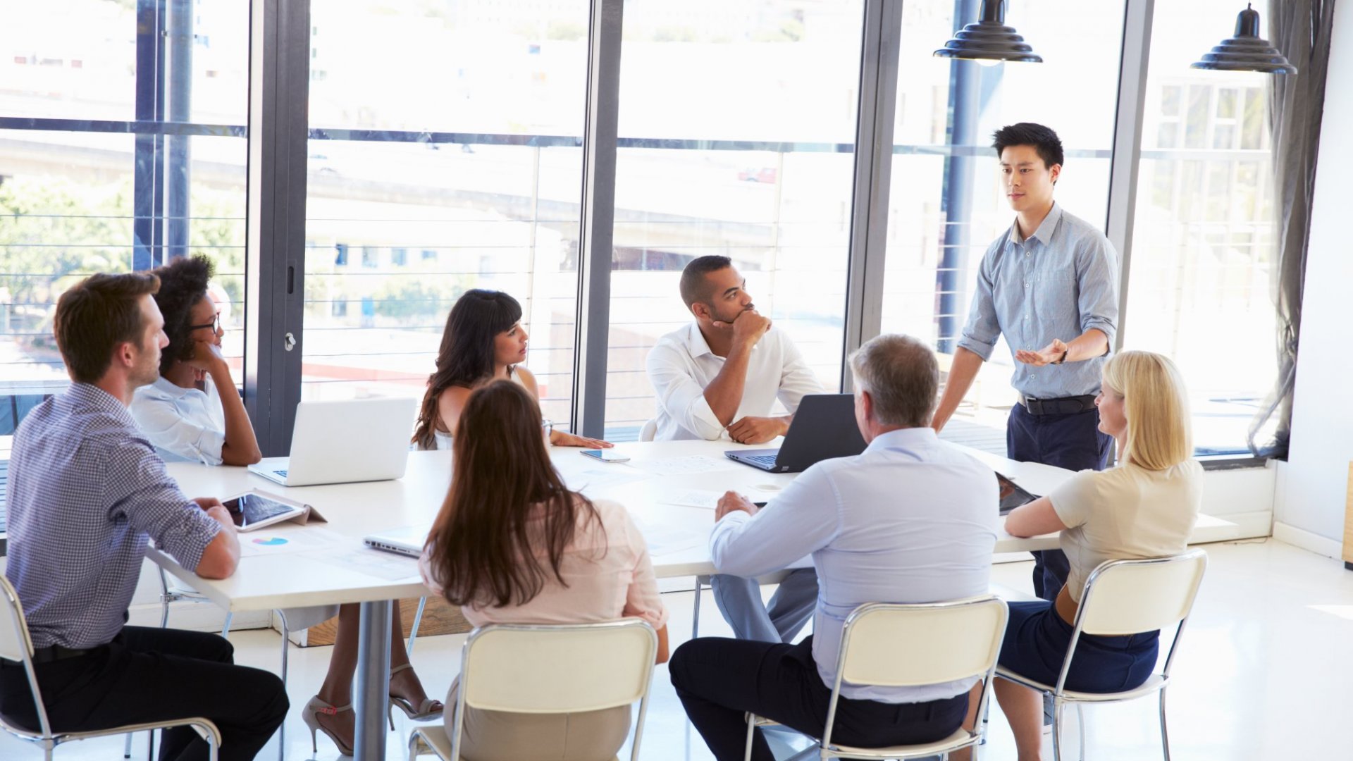 Eight people discussing PPC management services
